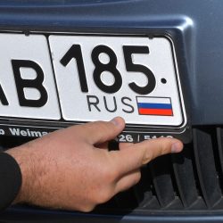 8293457 11.10.2022 A driver installs Russian license plate, outside a traffic police office, in Melitopol, Zaporizhzhia region territory, that has accessed Russia.,Image: 729951585, License: Rights-managed, Restrictions: Editors' note: THIS IMAGE IS PROVIDED BY RUSSIAN STATE-OWNED AGENCY SPUTNIK., Model Release: no, Credit line: Profimedia